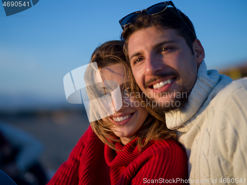 Image of couple on a beach at autumn sunny day