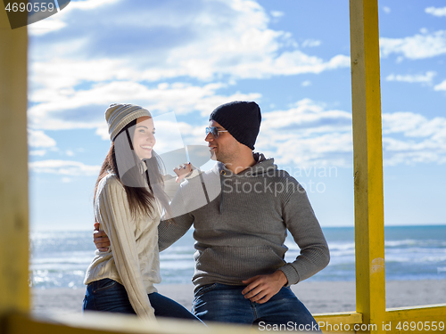 Image of Couple chating and having fun at beach bar