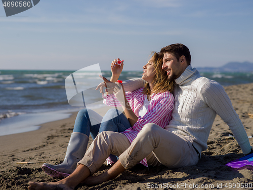 Image of young couple enjoying time together at beach