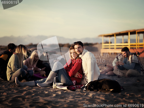 Image of couple on a beach at autumn sunny day