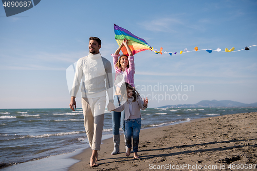 Image of happy family enjoying vecation during autumn day