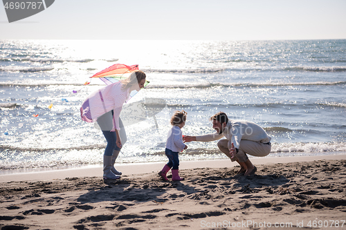 Image of happy family enjoying vecation during autumn day