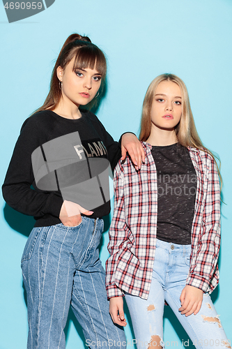 Image of Close up fashion portrait of two young pretty hipster teens