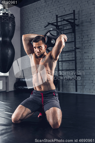 Image of The athlete trains hard in the gym. Fitness and healthy life concept.