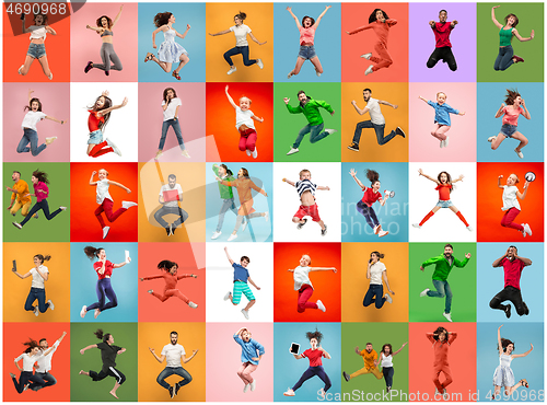 Image of Freedom in moving. Pretty young women and men jumping against colorful background