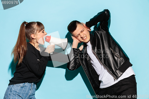 Image of Portrait of young emotional female student with megaphone