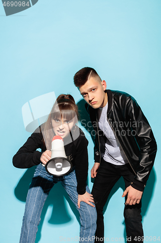 Image of Portrait of young emotional female student with megaphone