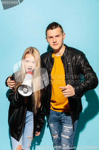 Image of Portrait of young emotional female student with megaphone