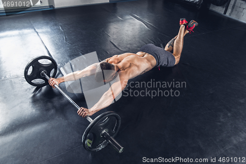 Image of The athlete trains hard in the gym. Fitness and healthy life concept.