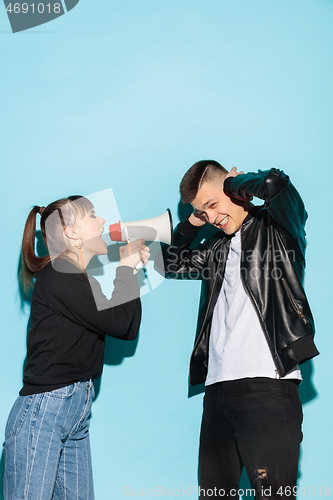 Image of Portrait of young emotional female student with megaphone