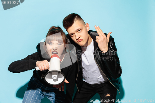 Image of Portrait of young emotional female student with megaphone