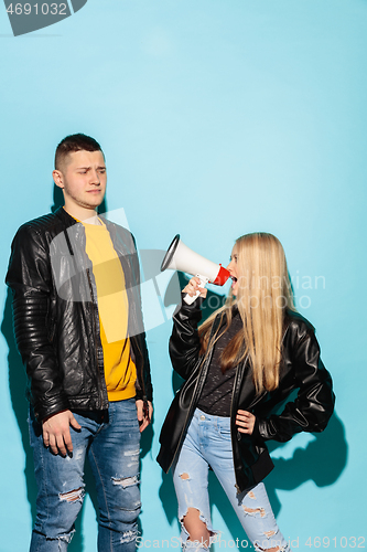 Image of Portrait of young emotional female student with megaphone