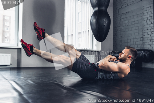 Image of The athlete trains hard in the gym. Fitness and healthy life concept.