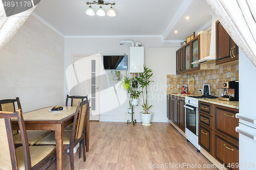 Image of Interior of a spacious living room and kitchen with a classic wood grain design