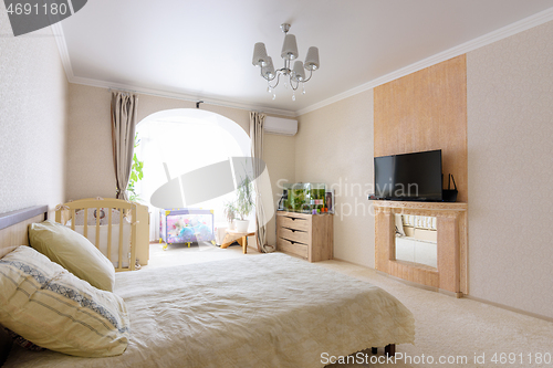 Image of Interior of a spacious bedroom with furniture and a nice light design