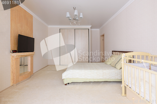 Image of Spacious bedroom interior with newborn toddler practice