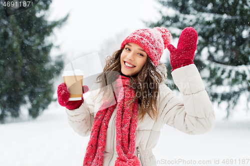 Image of happy teenage girl with coffee in winter park