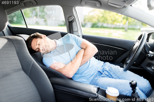 Image of tired man or driver sleeping in car