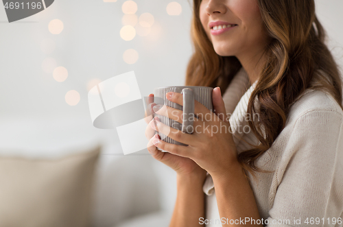 Image of close up of happy woman with cup of coffee at home