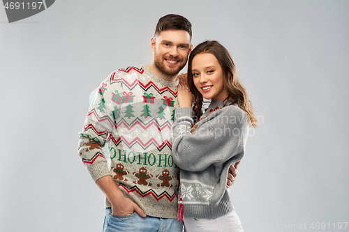 Image of happy couple at christmas ugly sweater party