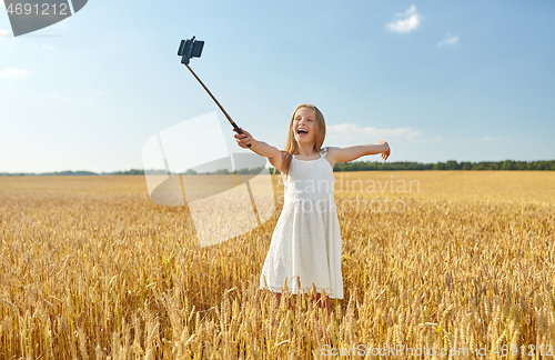 Image of happy young girl taking selfie by smartphone