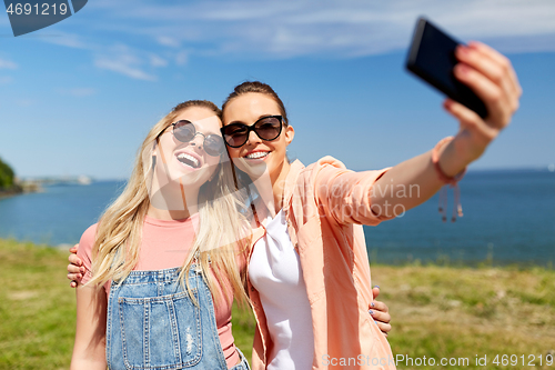 Image of teenage girls or friends taking selfie in summer