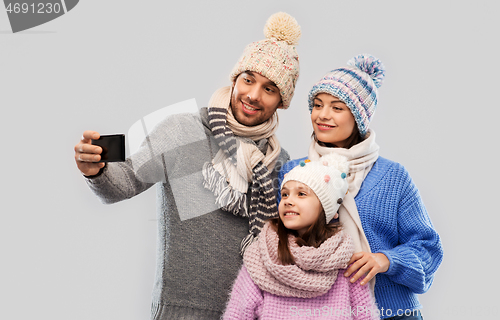 Image of happy family taking selfie by smartphone