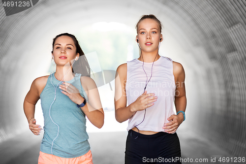 Image of women or female friends with earphones running