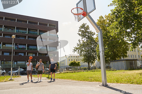 Image of group of male friends going to play basketball