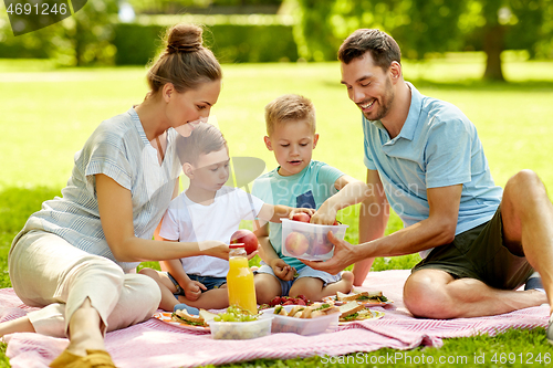 Image of happy family having picnic at summer park