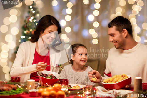 Image of happy family having christmas dinner at home