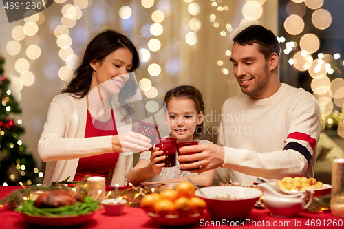 Image of happy family having christmas dinner at home