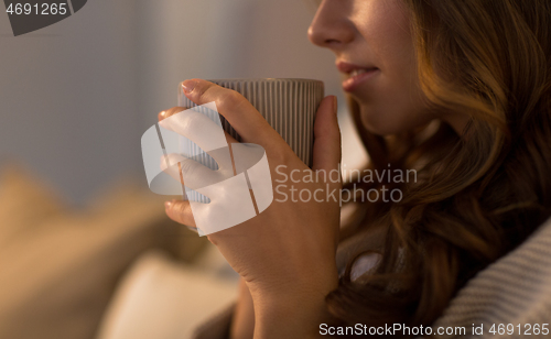 Image of close up of happy woman with cup of coffee at home