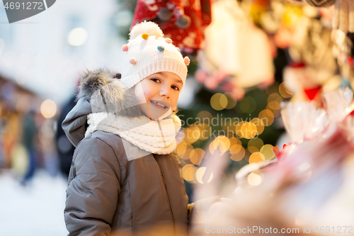 Image of happy little girl at christmas market in winter