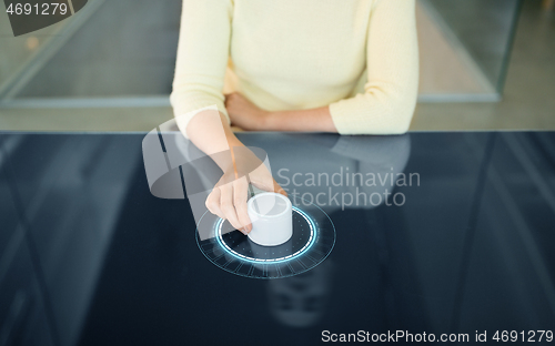 Image of woman with control knob on interactive panel