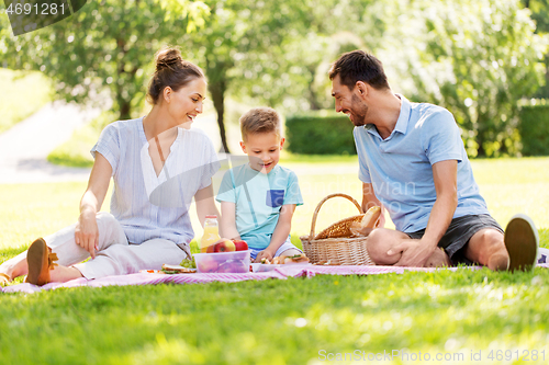 Image of happy family having picnic at summer park