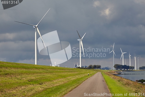 Image of Wind tubines along the waterside