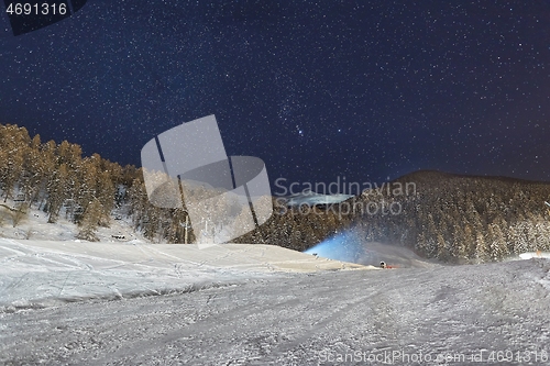 Image of Skiing slope at night below starry sky