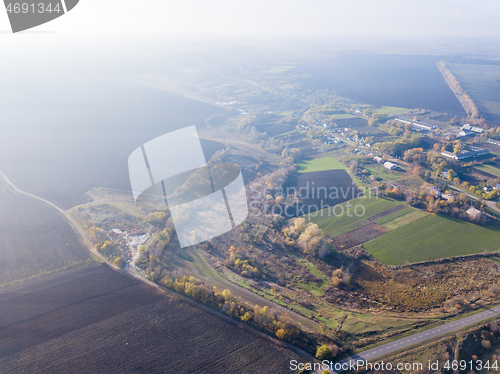 Image of Aerial view from the drone above agricultural fields, manufacturing areas and landfill site.