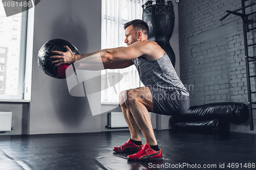 Image of The athlete trains hard in the gym. Fitness and healthy life concept.