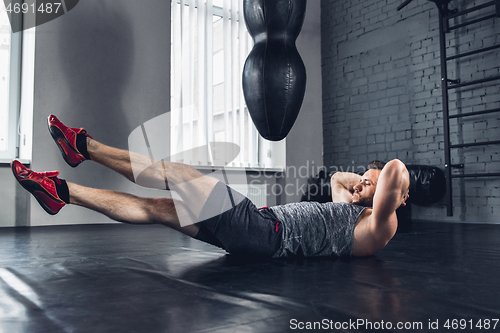 Image of The athlete trains hard in the gym. Fitness and healthy life concept.