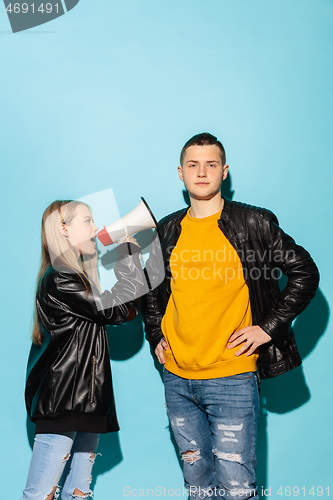 Image of Portrait of young emotional female student with megaphone