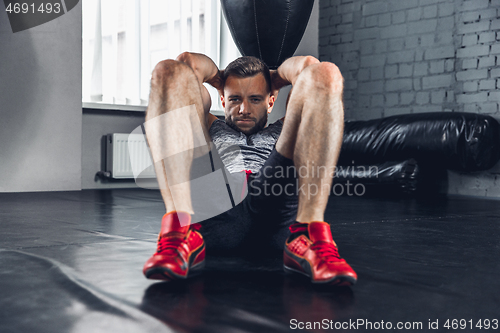 Image of The athlete trains hard in the gym. Fitness and healthy life concept.