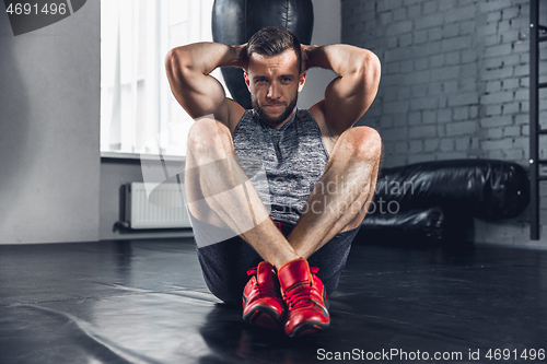 Image of The athlete trains hard in the gym. Fitness and healthy life concept.