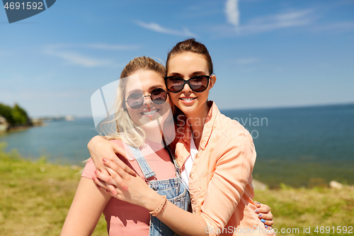 Image of teenage girls or best friends at seaside in summer