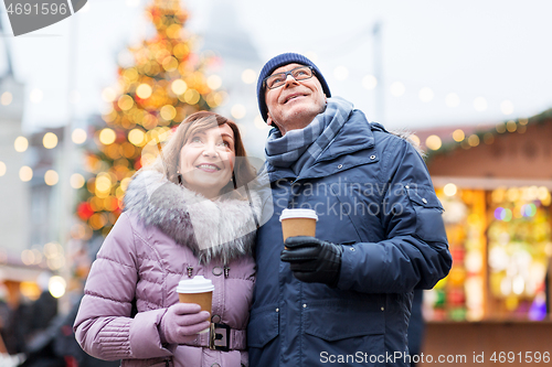 Image of senior couple with coffee at christmas market