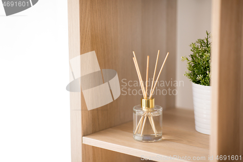 Image of aroma reed diffuser on wooden shelf