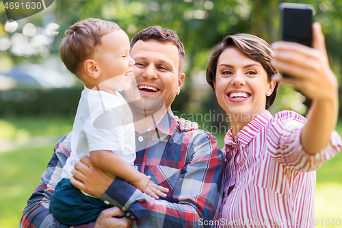 Image of happy family taking selfie at summer park