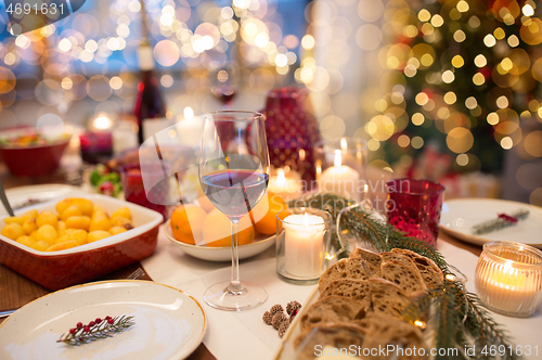 Image of glass of red wine and food on christmas table