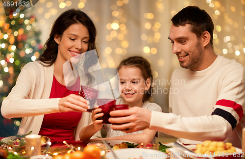 Image of happy family having christmas dinner at home